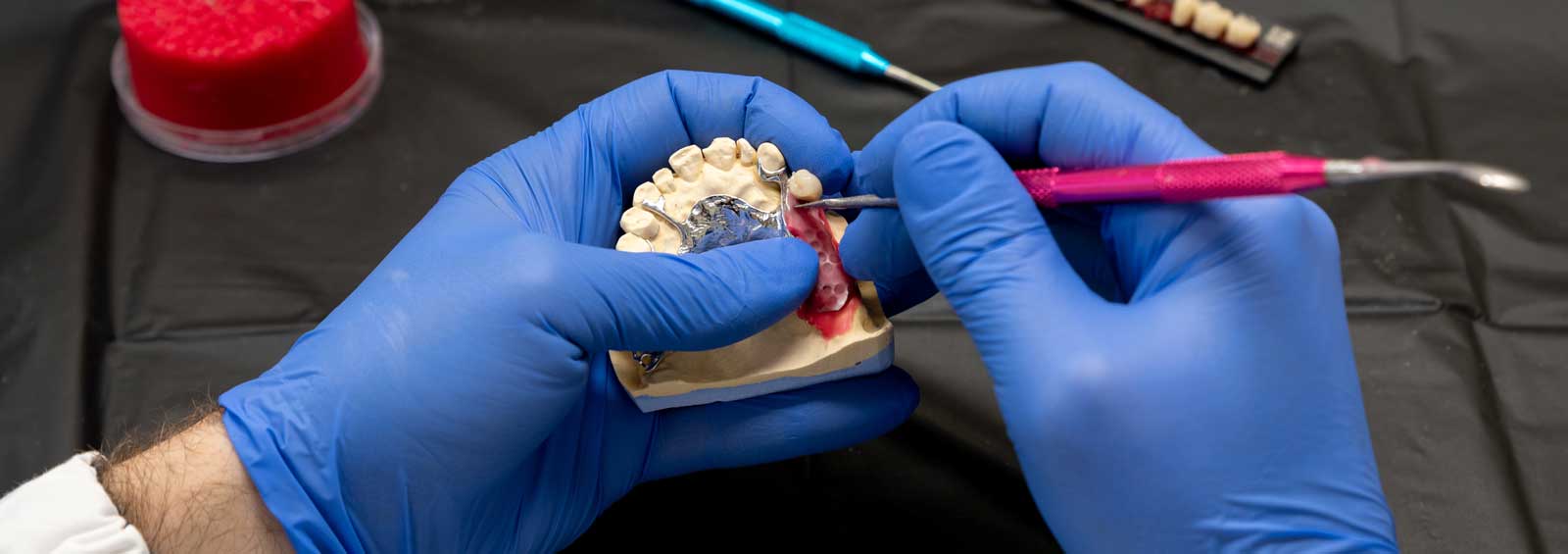 Dentist working on patient dentures at Dan's Denture Clinic